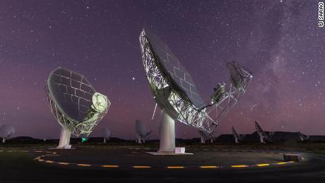 MeerKAT radio telescope dishes can be seen under the starry sky in Karoo, South Africa. 