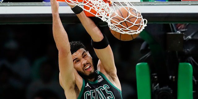 Boston Celtics' Jason Tatum dunks against the Miami Heat during the first half of Game 6 of the NBA Playoffs Finals on Friday, May 27, 2022, in Boston.  (Photo by Associated Press/Michael Dwyer)