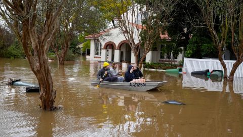 People paddling on a flooded street in Windsor, Australia, July 5, 2022