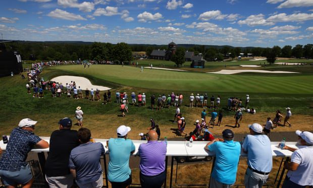Fans are seen playing on the 10th green lawn from a distance in Bedminster.