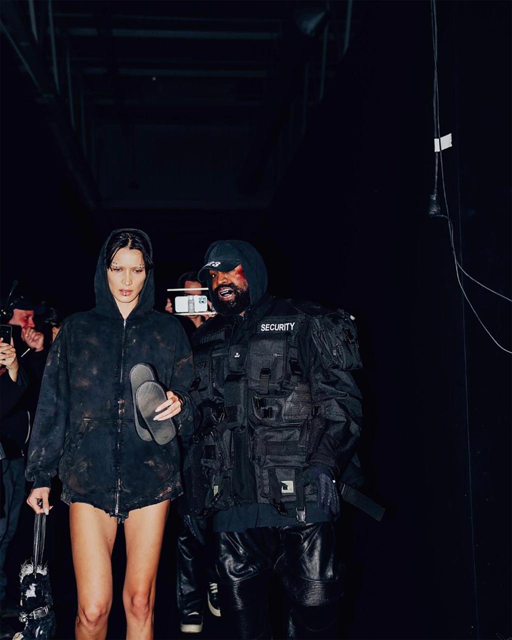 Kanye West appears on the catwalk during the muddy Balenciaga Fashion Week in Paris