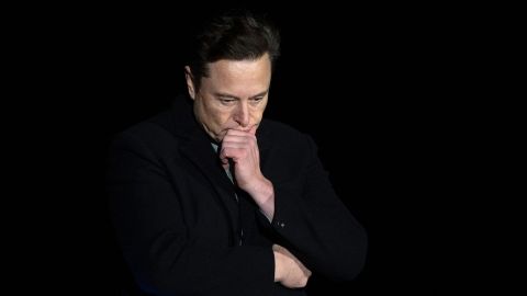 Elon Musk pauses and looks down as he speaks during a press conference at the SpaceX StarBus facility near the village of Boca Chica in South Texas on February 10, 2022. 