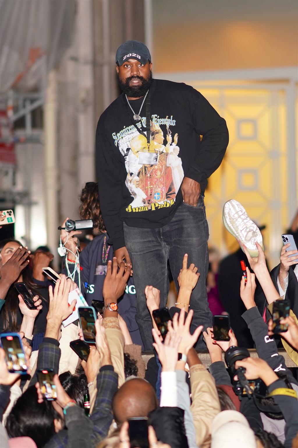 Kanye West wears a White Lives Matter jacket while celebrating with fans in Paris