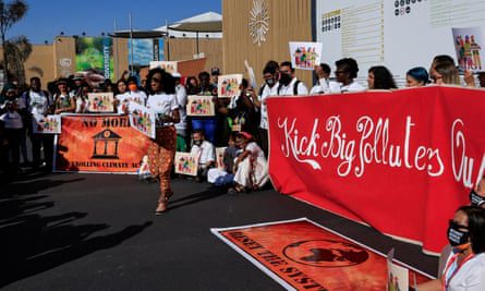 Climate activists protest against major polluters at the Sharm el-Sheikh International Convention Center.