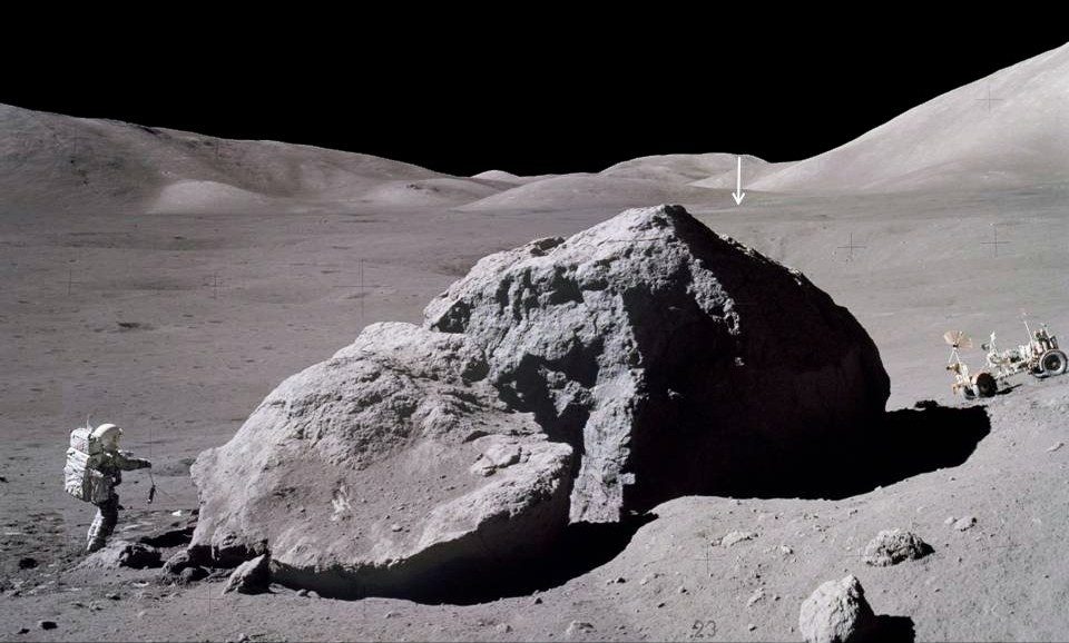 The surface time of Apollo 17, the longest-lived program on the Moon, was three days, two hours, and fifty-nine minutes.  The image shows Jack Schmidt from the Apollo 17 spacecraft carrying a scorpion back toward the lunar module after observing and sampling the eastern side of a massive boulder.  The vertical arrow in the distance points to the Lunar Module Challenger, located about 2 miles (3.1 km) away.