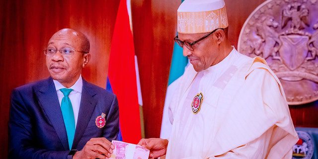 FILE: Godwin Emifiele, left, President of the Central Bank of Nigeria (CBN), attends the presentation of the new banknotes after Nigerian President Muhammadu Buhari, right, unveiled the newly designed banknotes due to counterfeiting and increasing security problems on November 23, 2022, in Abuja, Nigeria.